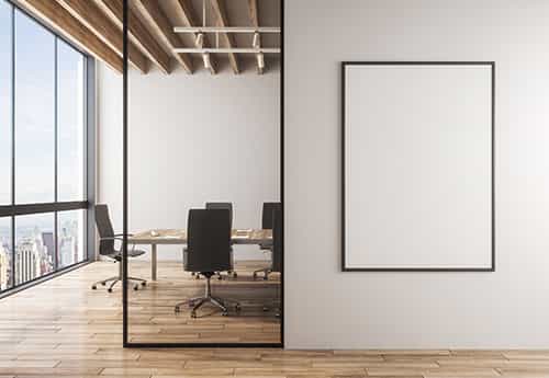 an empty conference room in an office building with a blank canvas on the wall